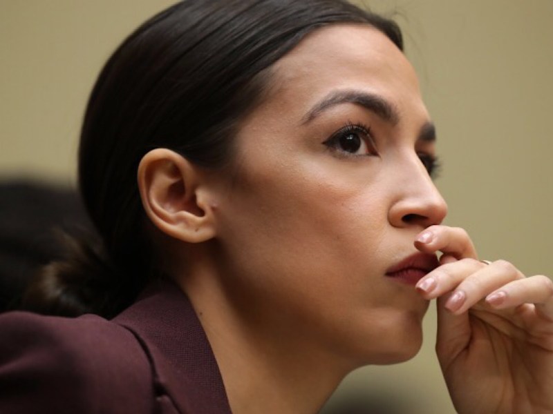 Rep. Alexandria Ocasio-Cortez (D-NY) listens to testimony by Michael Cohen, former attorney and fixer for President Donald Trump, before the House Oversight Committee on Capitol Hill February 27, 2019 in Washington, DC. Last year Cohen was sentenced to three years in prison and ordered to pay a $50,000 fine for tax evasion, making false statements to a financial institution, unlawful excessive campaign contributions and lying to Congress as part of special counsel Robert Mueller's investigation into Russian meddling in the 2016 presidential elections. (Photo by Chip Somodevilla/Getty Images)