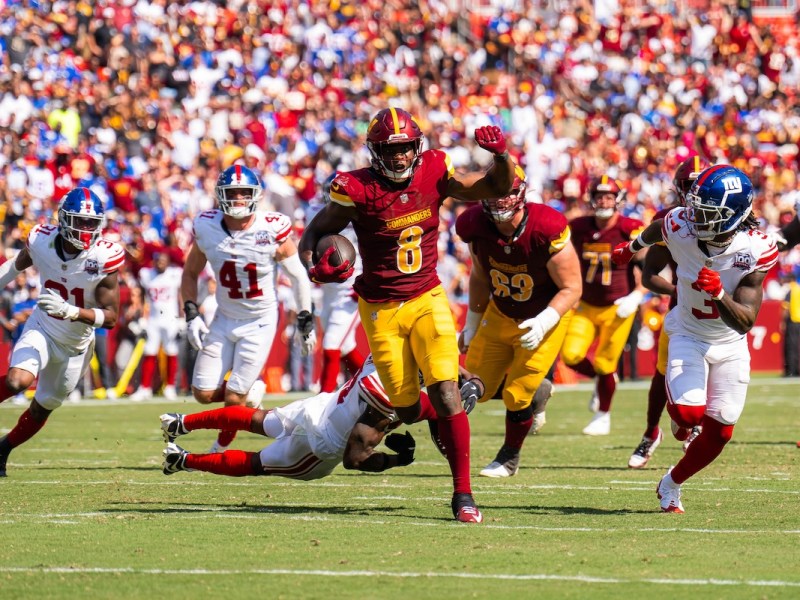 Commanders running back Brian Robinson Jr. advancing in rushing yards striking past the Giants defense. (Abdullah Konte/The Washington Informer)